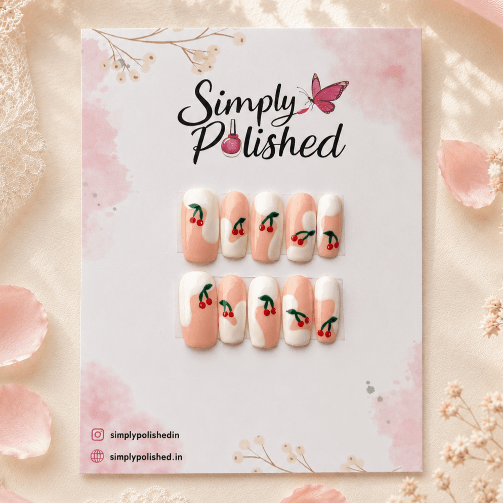 Handcrafted press-on nails with glossy cherry-red nail art on a natural base.