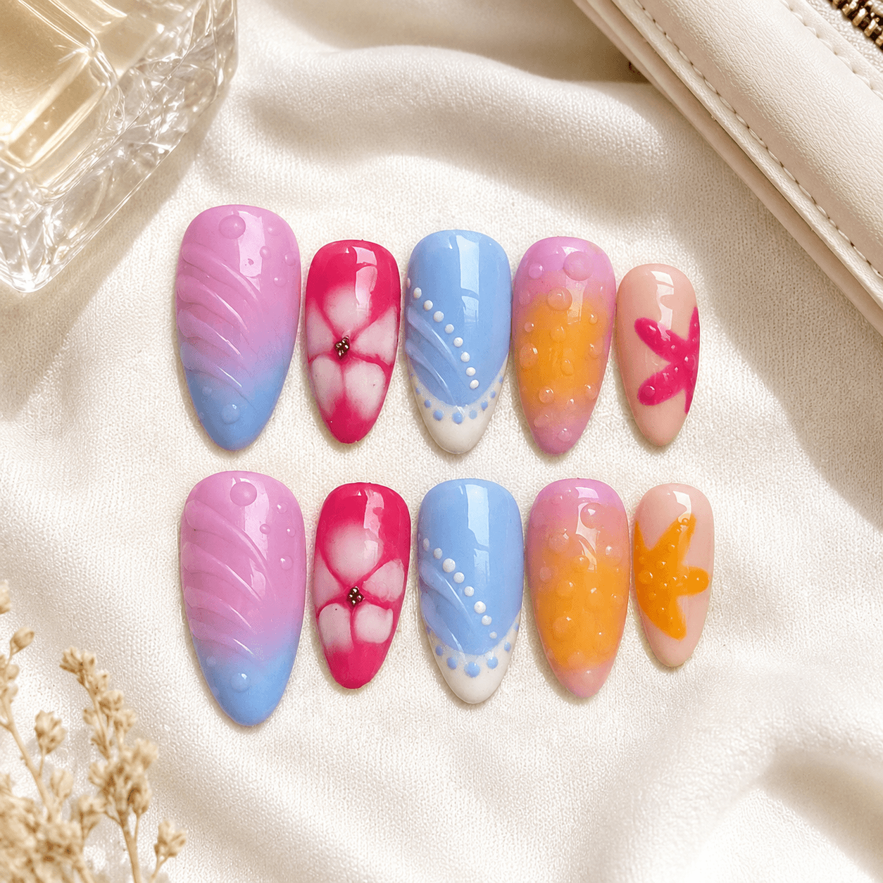 Handcrafted press-on nails with ocean-inspired blue tones and a glossy finish.