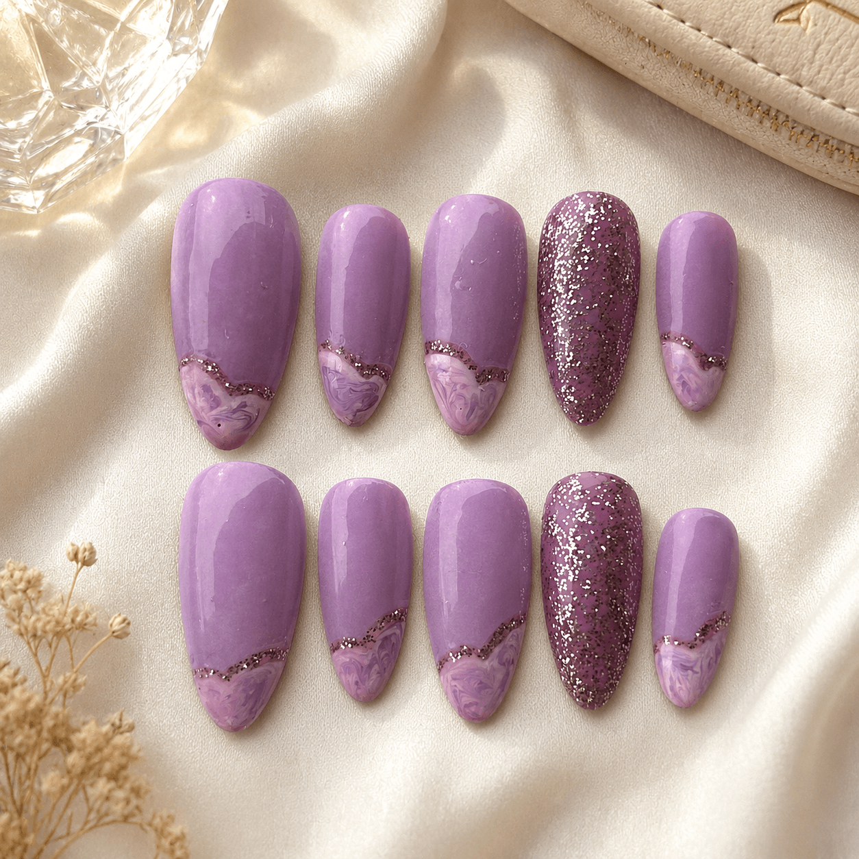 Handcrafted press-on nails with soft lavender marble swirls and a glossy finish.