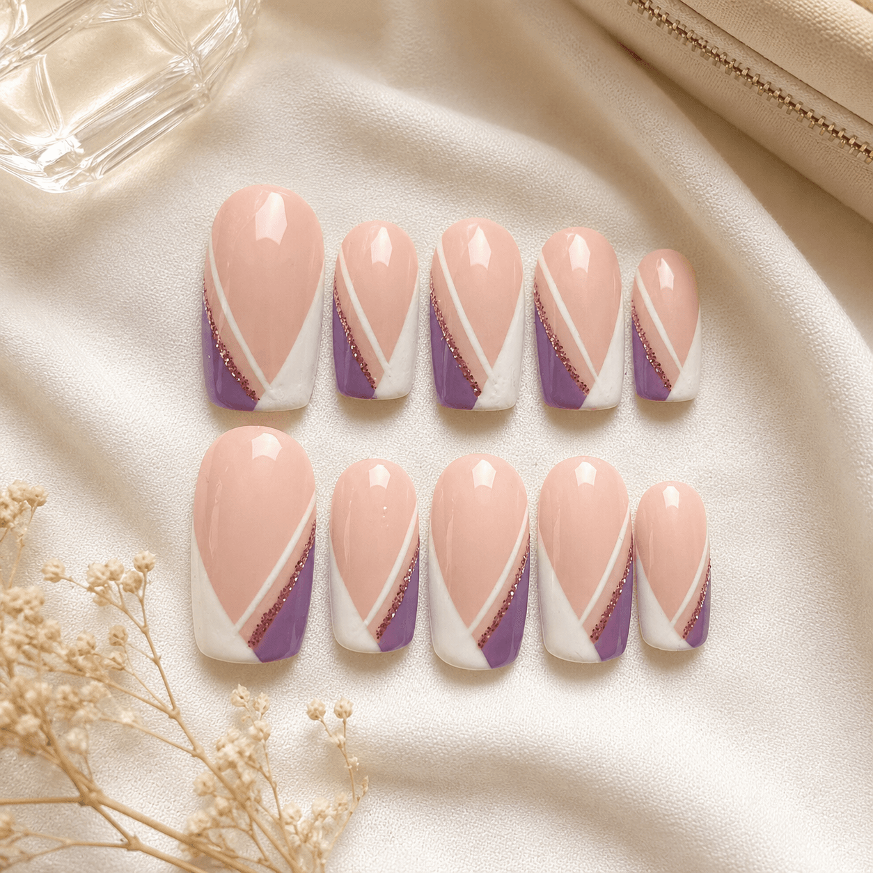 Handcrafted press-on nails with lilac purple glitter details and a glossy finish.