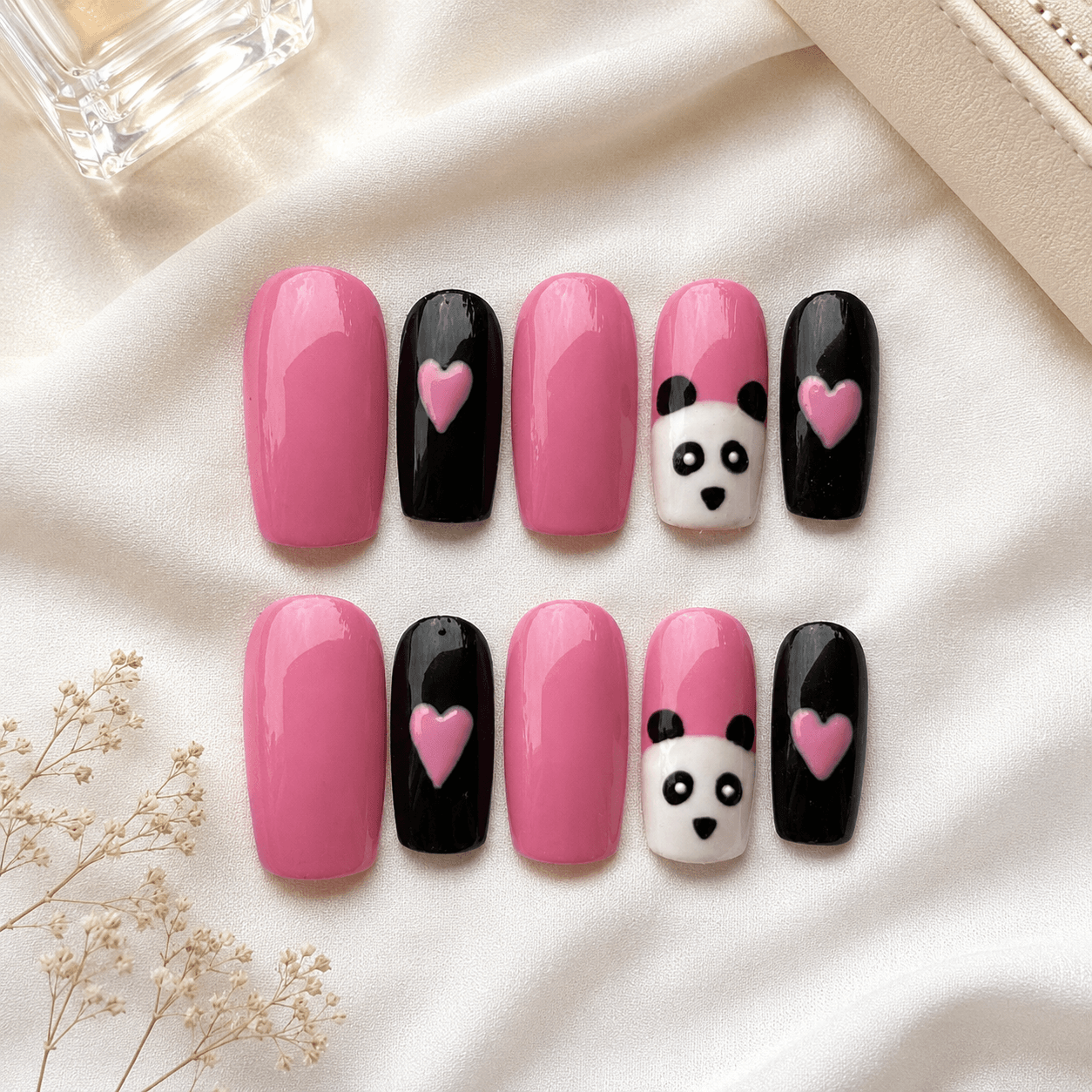 Handcrafted press-on nails with cute panda-inspired black and white nail art.