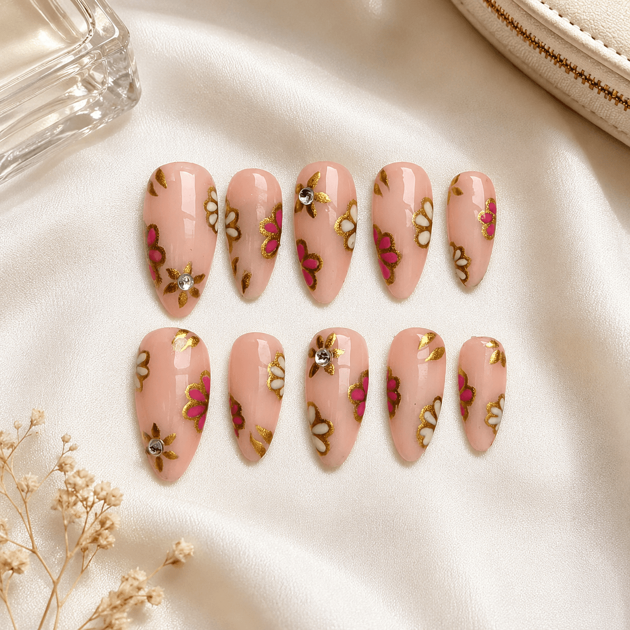 Handcrafted press-on nails with delicate floral art and a glossy finish.