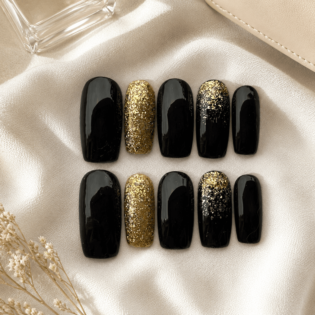 Handcrafted press-on nails with black sparkle and starry night-sky nail art.